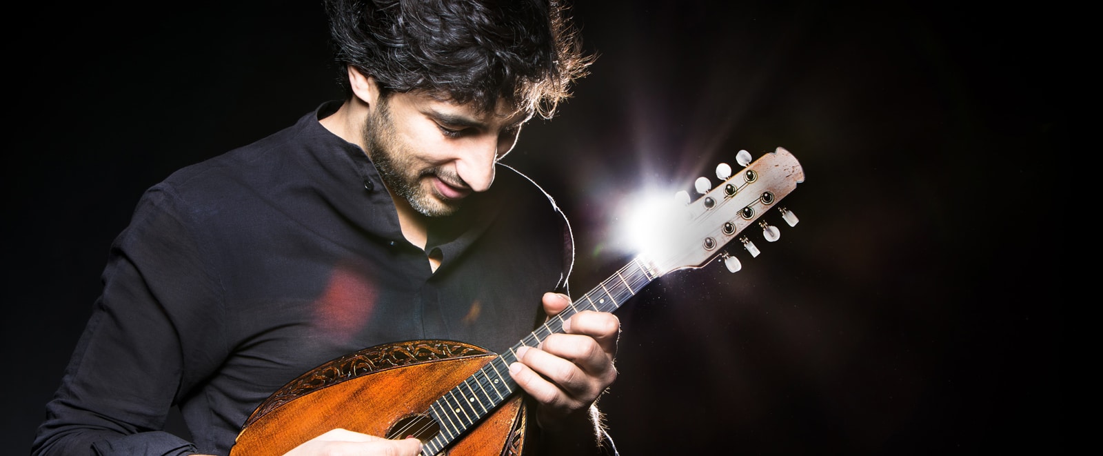 Avi Avital holding a mandolin